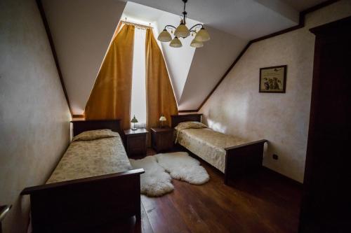 a bedroom with two beds and a window at Gnizdo Golubky in Shaian