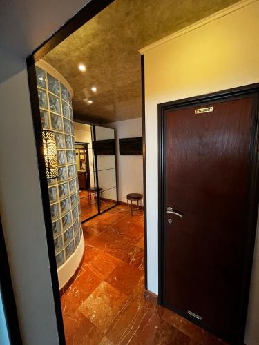 a hallway with a door and a room with a table at Ground floor in Brussels