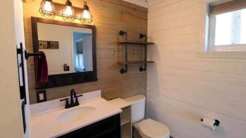 une salle de bain avec un lavabo, des toilettes et un miroir dans l'établissement Sunset Retreat, à North Cape May