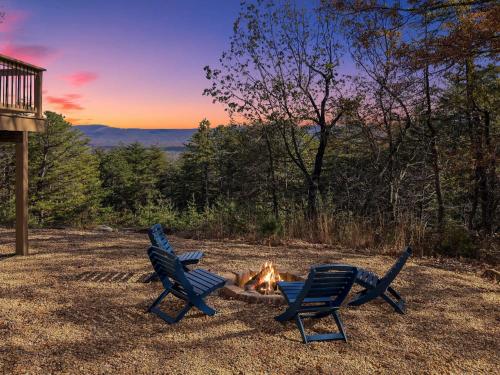 three chairs sitting around a fire in a yard at Amazing Views Fire Pit & Grill near Wardensville in Delray