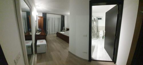 a large mirror in a room with a bedroom at Casa Bogdan in Uricani
