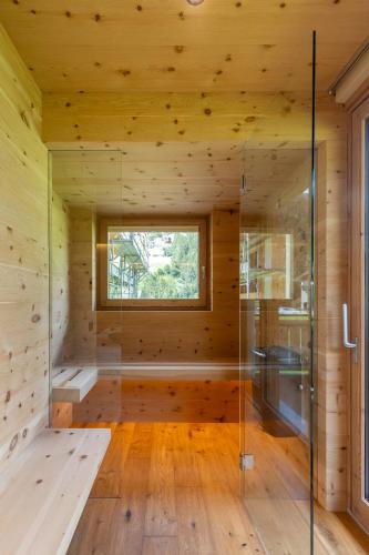 a sauna with a window in a wooden cabin at Mot chalet in Valdidentro