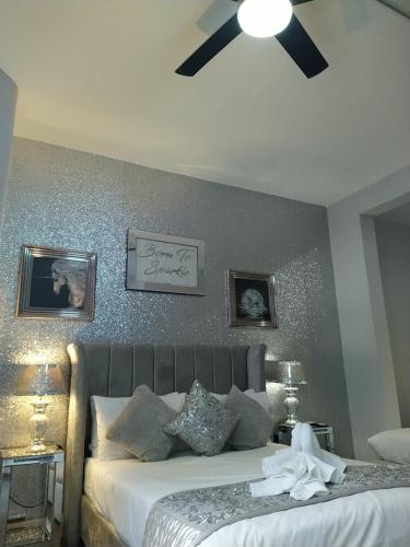 a bedroom with a bed with a ceiling fan at The Dreamcatcher Hotel in Blackpool