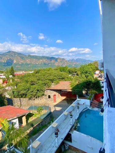 a view from the balcony of a house with a swimming pool at Hotel Casa Maximiliano in Tepoztlán