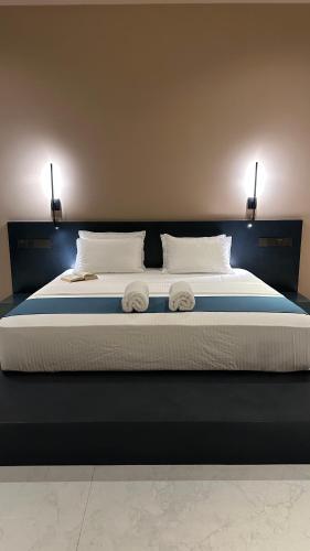 a large bed with two towels on top of it at Serenity Villa in Dickwella