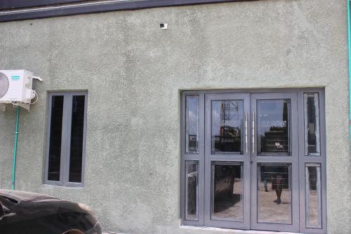 a building with a large glass door on it at Folks Apartment in Mama