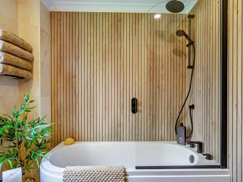 a bath tub in a bathroom with a shower at 6 Bed in Stanley 96289 in Stanley