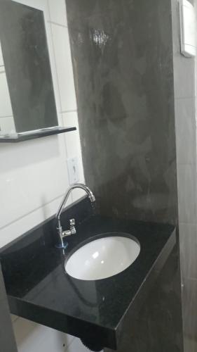 a bathroom with a black sink and a mirror at Studio Jaguary - Monte Verde in Camanducaia