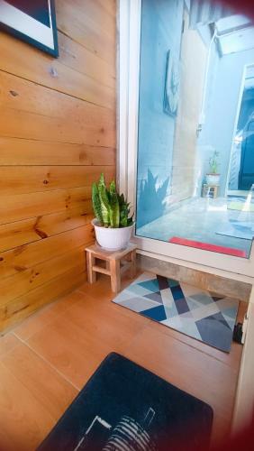 a room with a potted plant and a window at Stop by stay Pai in Pai