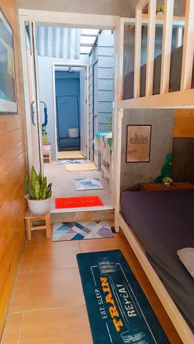 a room with a bunk bed and a doorway at Stop by stay Pai in Pai