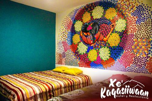 a bedroom with a painting on the wall at Xe 'Gakasiiwaan in San Juan La Laguna