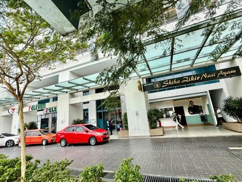 a building with cars parked in front of it at Infinitum Luxurious Sky Suites in Kuala Lumpur