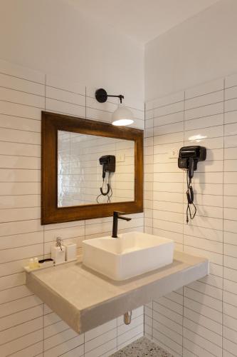 a bathroom with a sink and a mirror at Sea Escapes Resort in Thong Sala