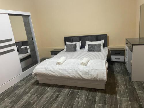 a bedroom with a bed with white sheets and pillows at Домик Zara in Samarkand
