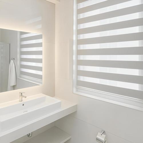 a white bathroom with a sink and a mirror at Penelope Apartments 15 in Xlendi