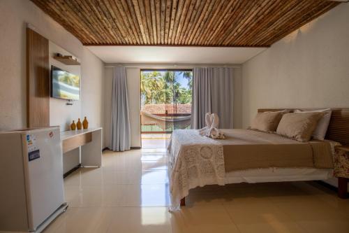 Ένα ή περισσότερα κρεβάτια σε δωμάτιο στο Vila Hayô