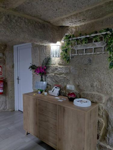 a stone room with a table with a cake on it at Casa Piedra Miranda. in Vilaboa