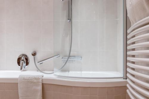 a shower with a glass door in a bathroom at Alpenresidenz am Mühlbach in Obergurgl