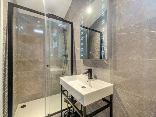 a bathroom with a sink and a shower at Sandbanks 2 bed Lodge with hot tub - L1 in Brynteg