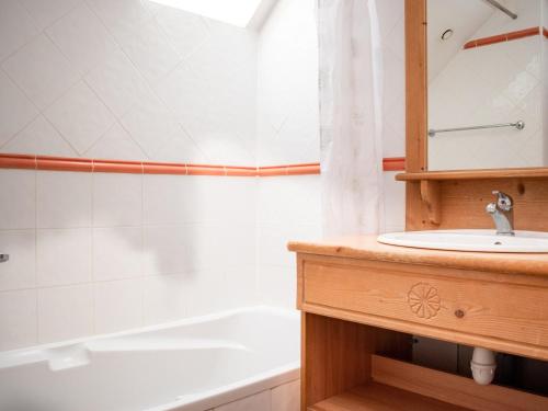 ein Badezimmer mit Waschbecken und Badewanne in der Unterkunft Charmant Chalet 6 Pers. avec Terrasse et Parking - Résidence Les Chalets de Praroustan, Pra Loup 1500 - FR-1-504-364 in Uvernet