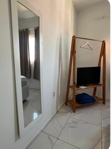 a mirror in a room next to a white wall at Apartamento da Kenia in Canoa Quebrada