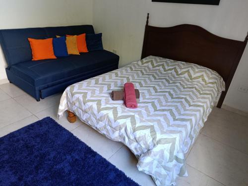 a bed and a couch in a room at Casa Montiel in Mérida