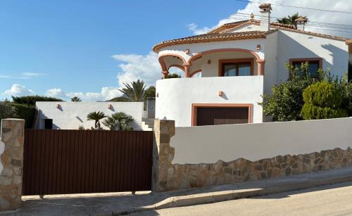 a white house with a fence at Villa Martí in Calpe