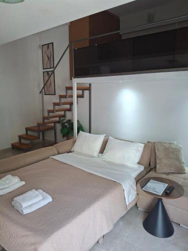 a bedroom with a large bed and a staircase at City Loft in Sparta