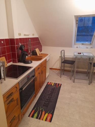 a kitchen with a sink and a stove top oven at Zimmer mit Stall in Geestland