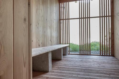 a bench in a room with a large window at Alpenresidenz am Mühlbach in Obergurgl