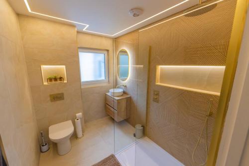 a small bathroom with a toilet and a shower at The View at Portpatrick. in Portpatrick