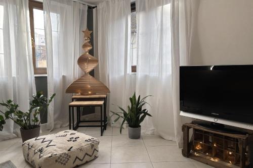 a living room with a flat screen tv and a table at Beautiful apartment of 67 m2 near Strasbourg in Bischheim