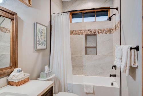 a bathroom with a shower and a toilet and a sink at Banner Bear in Banner Elk