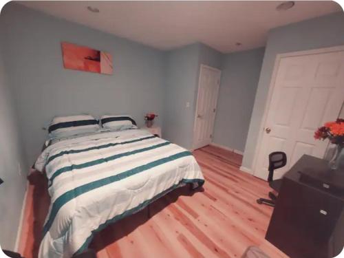 a bedroom with a bed and a wooden floor at Room in a mansion in Frederick