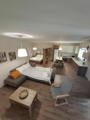 a large living room with a bed and a living room at Studio4U in Néa Karváli