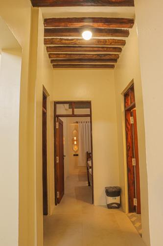 a hallway in a house with a wooden ceiling at Mkunazini House in Lamu