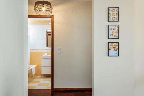 a hallway leading to a kitchen with a mirror at Nata7 Apartment in Funchal