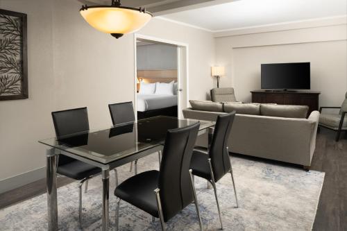 a living room with a table and a couch at DoubleTree by Hilton Providence Airport Warwick in Warwick