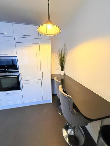 a meeting room with a table and chairs and a microwave at 200m to Wembley Stadium Guest Rooms in London