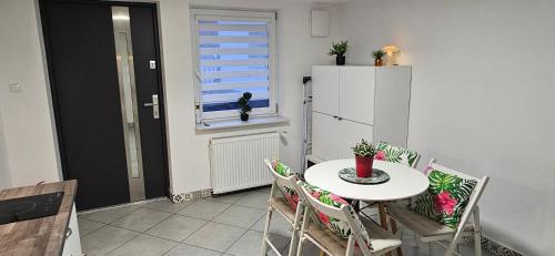 a kitchen with a table and a white refrigerator at Willa Joanna in Gdańsk