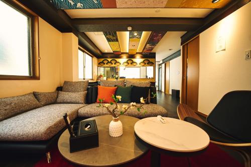 een woonkamer met een bank en een tafel bij The Kabuki-do Inn Haneda in Tokyo