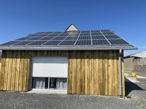 a house with solar panels on the roof at Le Nid in Abbaretz