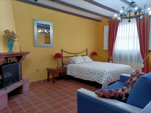 a bedroom with a bed and a fireplace at Casa Tajonaje in Alajeró
