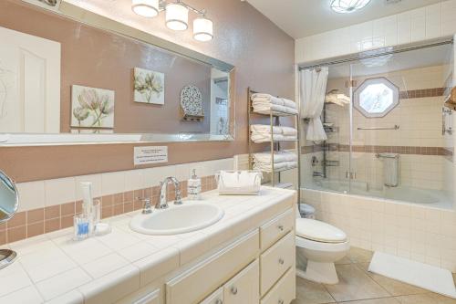 a bathroom with a sink and a toilet and a mirror at Outdoor Kitchen & Patio! Central Valley Hacienda in Atwater