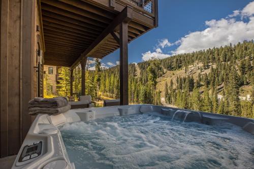a jacuzzi tub with a view of the mountains at Spanish Peaks - Highlands Cabin 59 in Big Sky