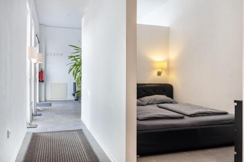 a bedroom with a black bed in a white room at Altenbeken- Ferienwohnung 1 in Altenbeken