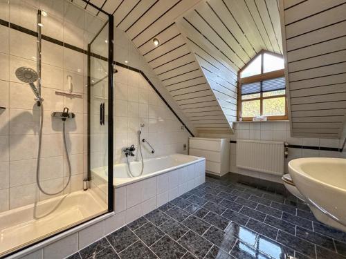 a bathroom with a shower and a tub and a sink at Riedenburg I in Buch