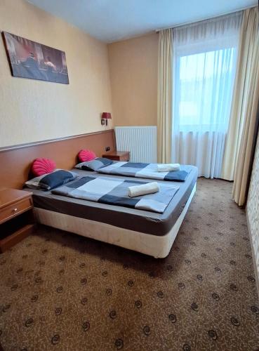 a bedroom with two beds and a large window at Silver Marina Apartment-Őrzött mélygarázs in Balatonfüred