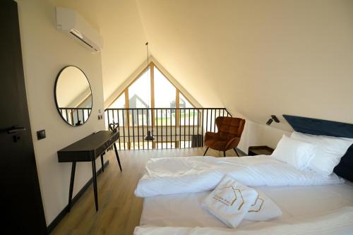 a bedroom with two beds and a mirror and a desk at Górskie Kąty Resort Michałkowa in Michałkowa