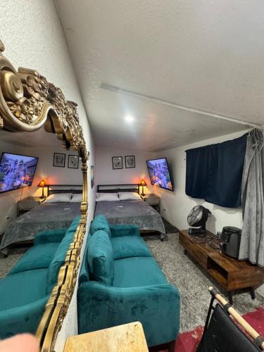 a living room with two beds and a couch at Tower District Hostel in Fresno